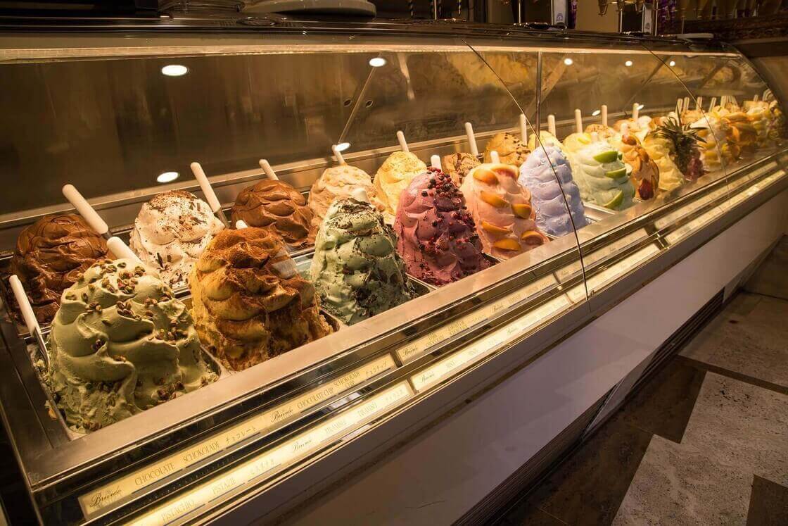 Photo of an artificial commercial gelato case filled with inauthentic gelato created with lab-created ingredients.