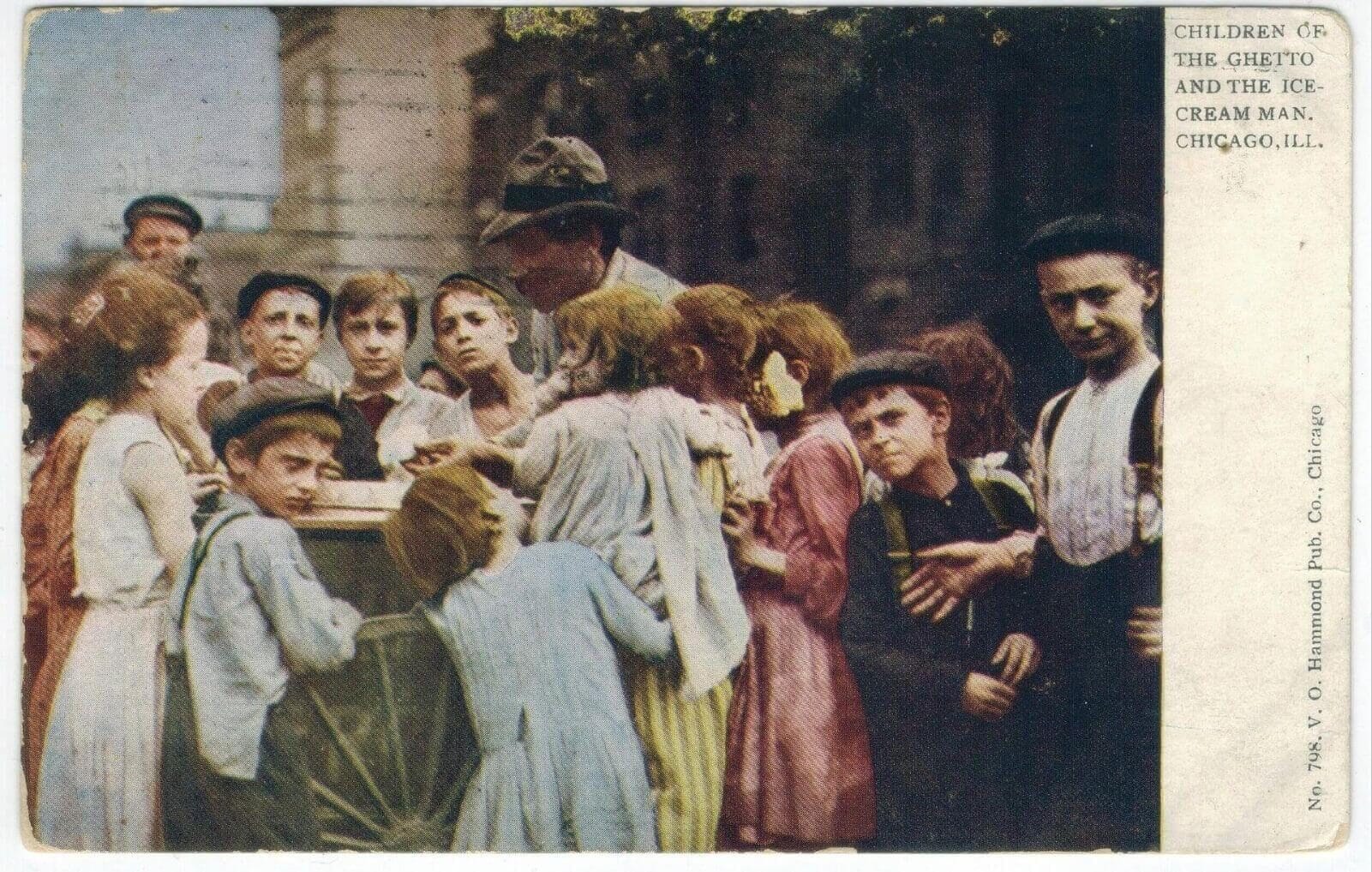 A 1909 photograph of an ice cream and gelato street vendor surrounded by children in Chicago.